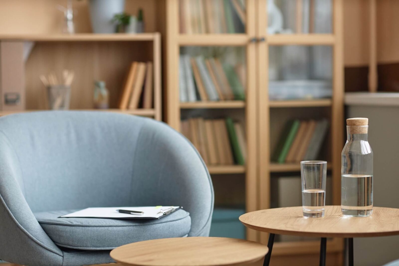 psychotherapists workplace with glass of clear water on table