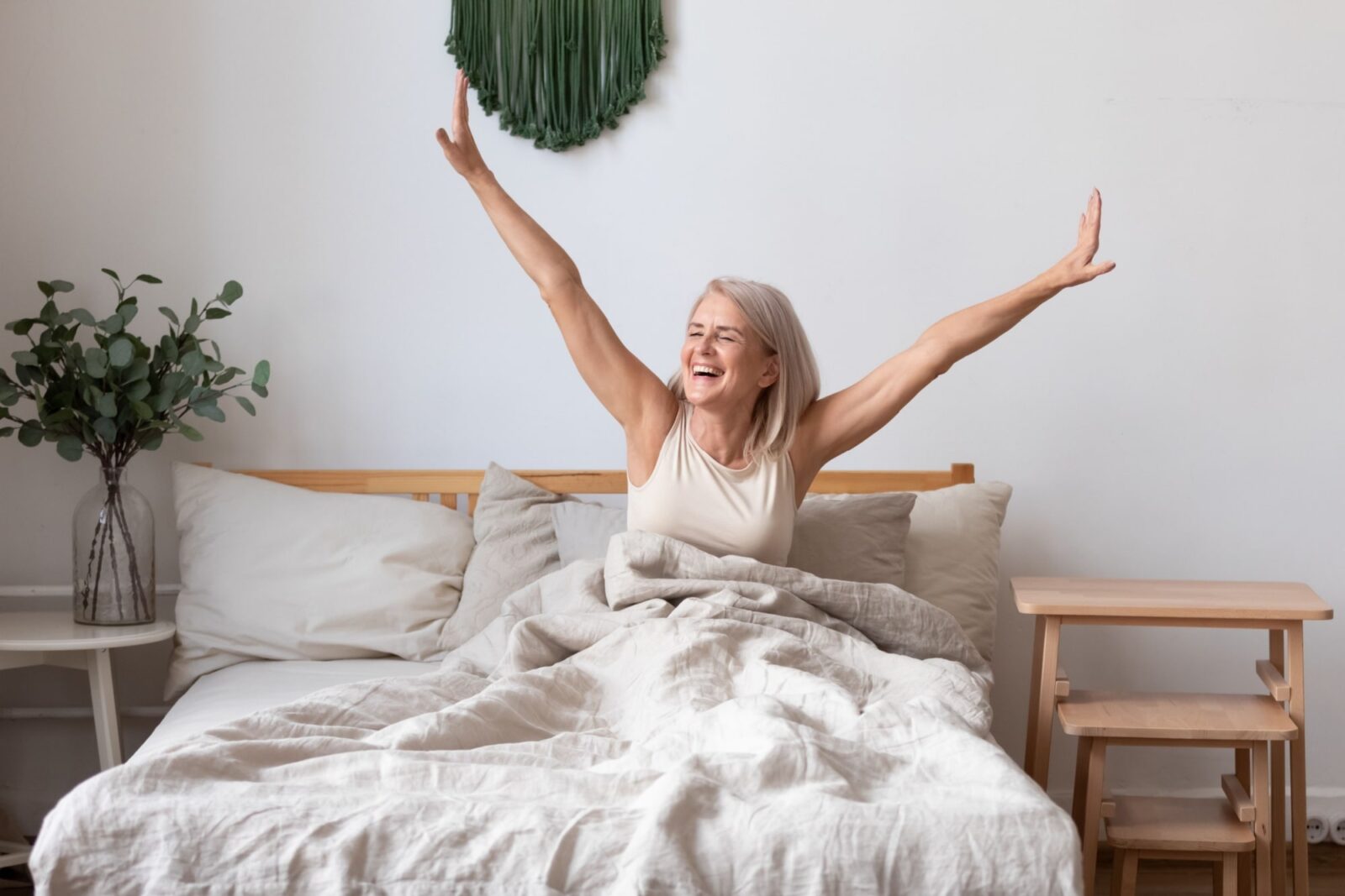 Refreshed elderly female wakes up in morning